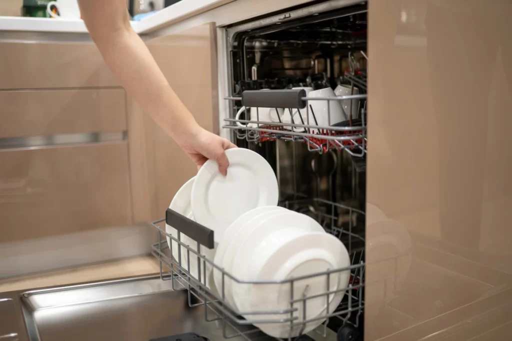 Close up of person unpacking dishwasher